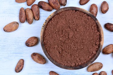 Bir kase ve fasulye masada kakao tozu