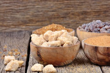 Ahşap arka plan üzerine bir kase şeker çeşitleri