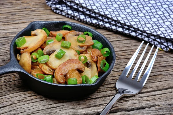 Champignon with green onion in a pan on table — Stock Photo, Image