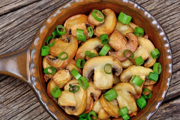 Champignon with green onion in a fry pan — Stock Photo, Image