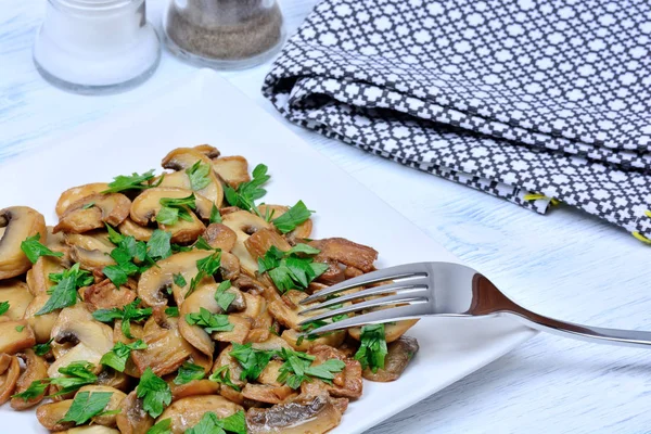Champignon in a plate with parsley — Stock Photo, Image