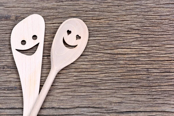 Happy wooden spoons on table — Stock Photo, Image