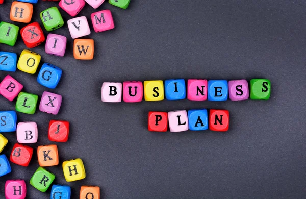 The words Business Plan on black background — Stock Photo, Image