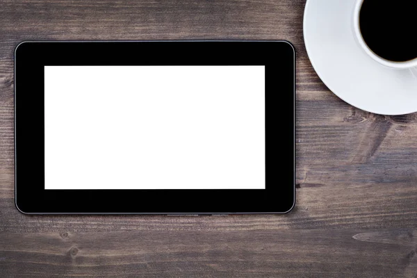 Empty tablet device with coffee cup on table