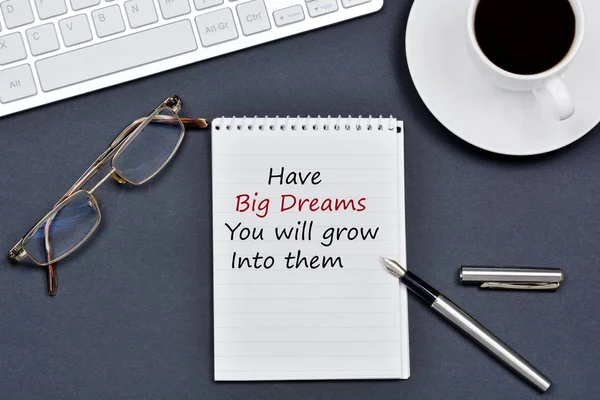 Have Big Dreams You will grow into them text on notebook