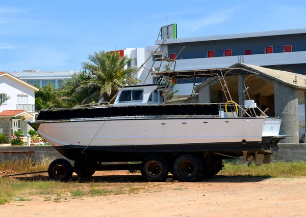 Boat with a motor on a trailer on land. Cyprus island