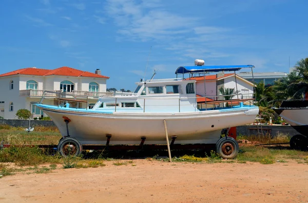 Boat with a motor on a trailer on land. Cyprus island