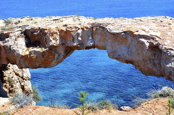 Natural stone arch on Mediterranean sea coast known as the \