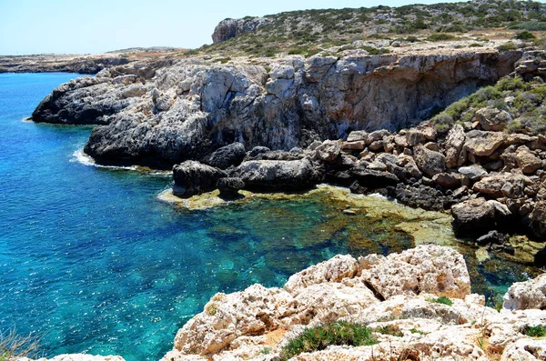The coast of the Mediterranean Sea and the purest azure sea, a bright sunny day. Beautiful seascape. Marine background