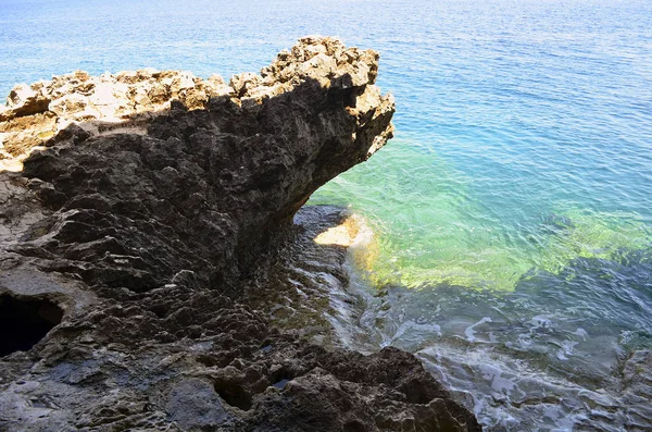 Rocky coast of the Mediterranean Sea, cliff on the background of the sea