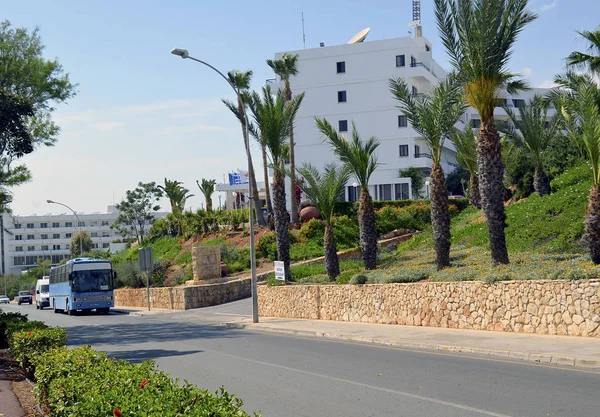 Ayia Napa, CYPRUS - APRIL 25, 2016: A small resort town on the Mediterranean coast. Bright sunny day, blue sky, road, palm trees, hotel.