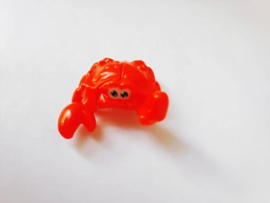 Beyaz arkaplanda kırmızı plastik yengeç izole edildi.