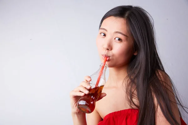 Chinese woman drinking soda
