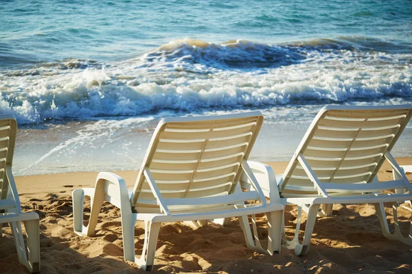 Sunrise on the beach with couches — Stock Photo, Image