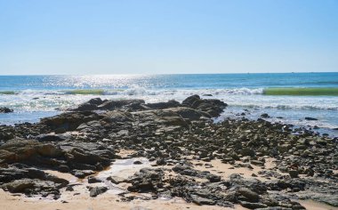 rocky coast view on sunny day              