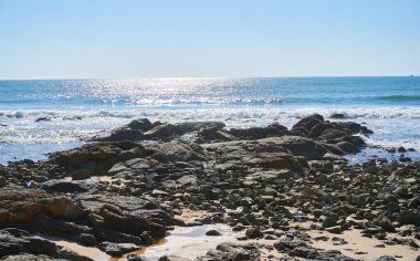rocky coast view on sunny day              