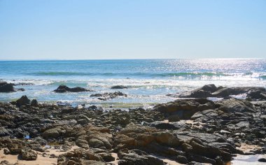 rocky coast view on sunny day              