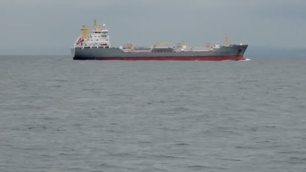 Large blue and red oil tanker sails on grey wavy sea — Stock Video