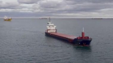 container ship approaches tanker for pumping of fuel