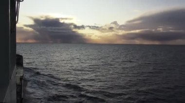 view from ship deck sailing in ocean on magnificent sunset
