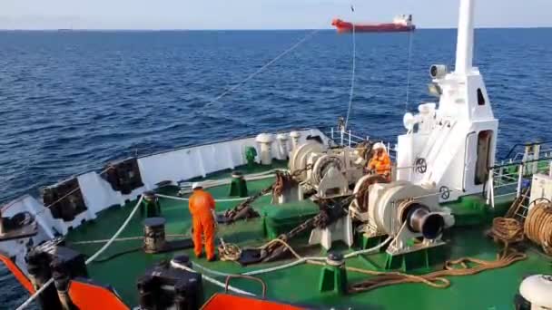 Matrozen in oranje uniform zware ligplaats eindigt op tanker — Stockvideo