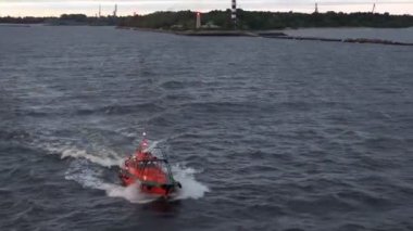 red pilot motorboat follows tanker Onyx sailing to raid