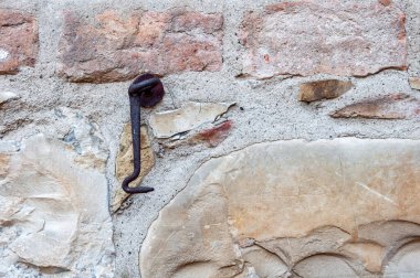 Antika İtalyan evinin taş ve tuğlalarından yapılmış, paslı demir kapı kancasıyla örülmüş tipik bir duvar..