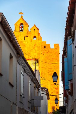 Camargue 'deki Saintes Maries de la Mer Kilisesi, Fransa' nın güneyinde su ve otlaklarla dolu, beyaz atlar, otlayan boğalar ve pembe flamingolarla ünlü bir bölge, Rhone Nehri 'nden geçiyor..