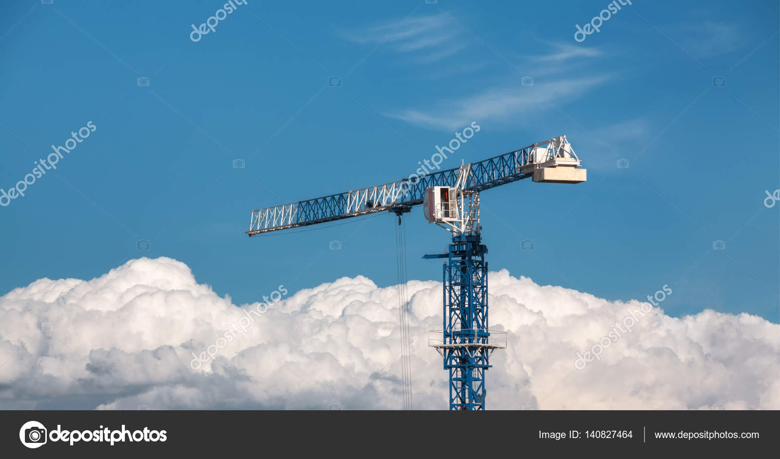 Construction crane blue and white above the clouds on the Construction crane blue and white above the clouds on the