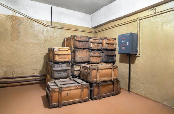 Old military wooden box with civilian gas masks in room