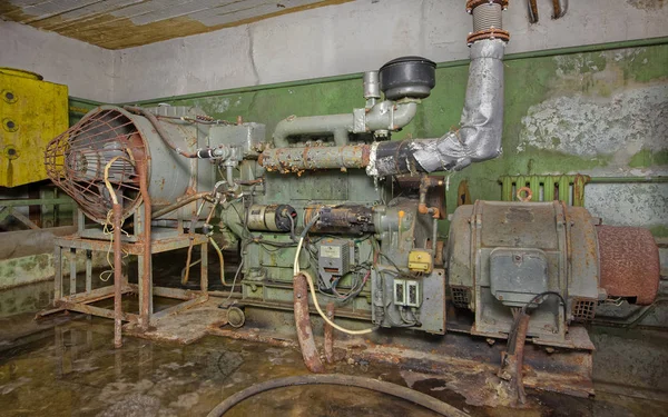 An old, rusty diesel generator to provide electricity to an underground shelter in an emergency.