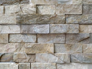 Modern stil mimarisinin pürüzsüz yüzeyi. İç veya dış dekorasyon için modern desenli taş duvar.