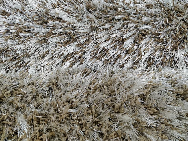 Primer plano del patrón de textura suave y mullida cálida de alfombra beige hecha de diferentes materiales para la decoración de interiores y suelos —  Fotos de Stock