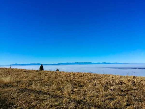 Fog and smog pollution seen from the high mountain nature where the air is clear and sky is blue, away from the city