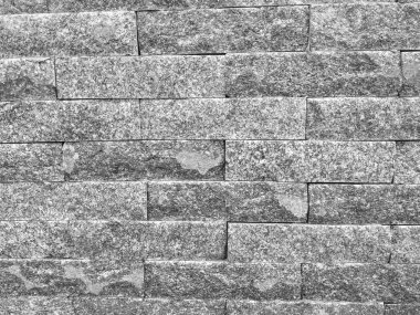 Modern kaya duvar arkaplanı, binanın dış duvarındaki tuğlalardan yapılmış kaba dokusu ve ilginç doğal deseni olan.