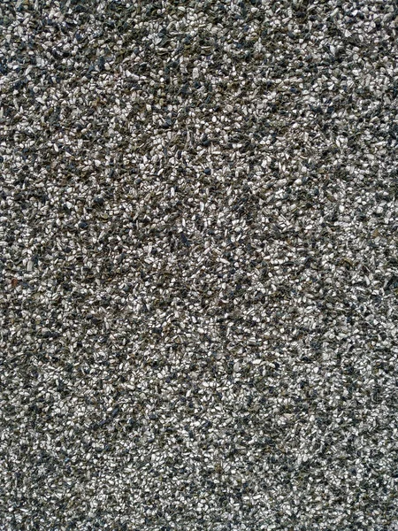 Surowa faktura starego czarno-białego szarego tradycyjnego muru z widocznym wzorem drobnych ziaren małych skał i innych materiałów na starym i starszym budynku — Zdjęcie stockowe