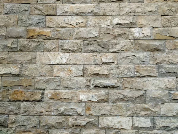 Fond de mur de pierre de roche moderne en briques sur un mur du bâtiment pour la maçonnerie extérieure avec texture rugueuse et motif naturel rétro antique intéressant — Photo