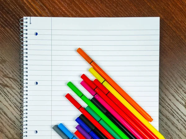 Empty white notebook with lines and colorful pens on top for taking notes on the lectures and better organization while studying and writing — Stock Photo, Image