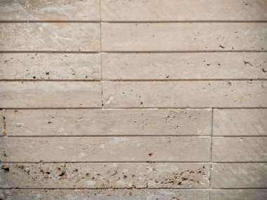 İlginç bir tasarım duvar kağıdı gibi çizgileri olan taş duvar ya da iç ya da dış yüzey kaplaması için bej renkli arkaplan