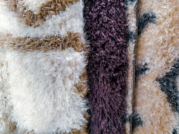 Colorful, warm and fluffy carpets rolled next to each other and shown for sale in the store for home interior decoration — 스톡 사진