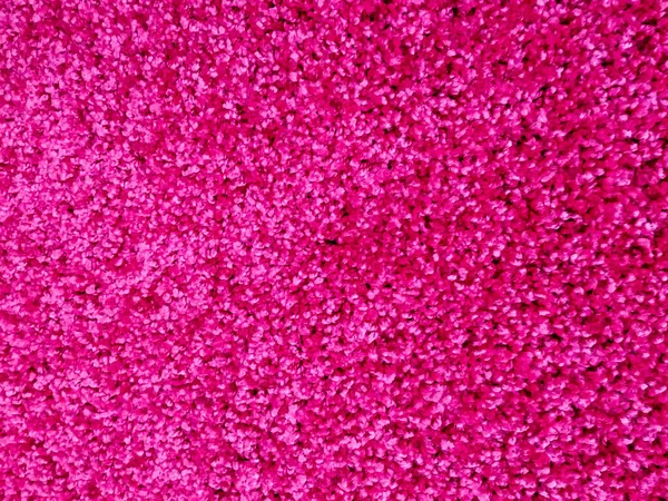 Яскраво-рожевий, пухнастий і теплий вовняний і м'який килим в суцільному кольорі для цікавого і сучасного дизайну оздоблення будинків — стокове фото