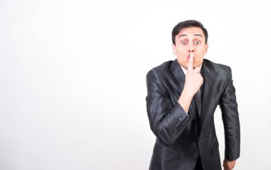 Takım elbiseli adam sessizlik istiyor. Beyaz arkaplan, orta çekim