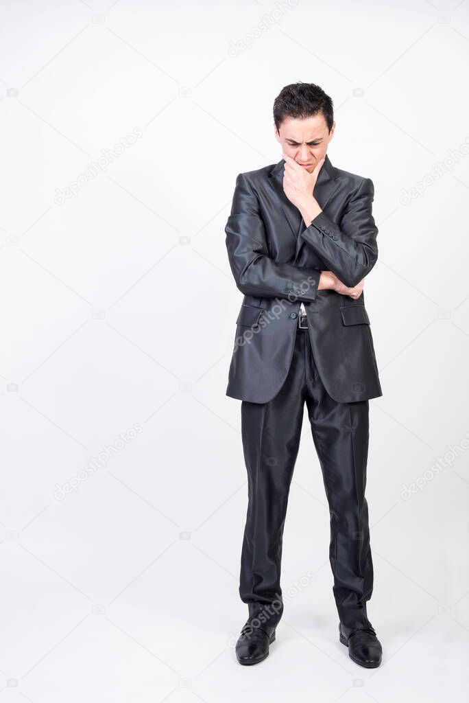 Worried man in suit. White background, full body