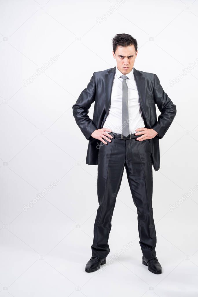 Challenging man in suit. White background. Full body