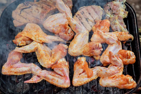 Grilled chicken wings on fire. Selective focus.