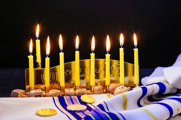 jewish holiday Hanukkah with menorah over wooden table