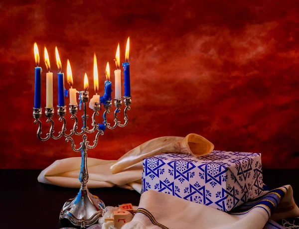 Jewish holiday Hanukkah creative background with menorah. View from above focus on .