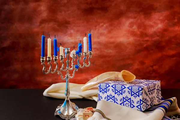 jewish holiday Hanukkah with menorah over wooden table