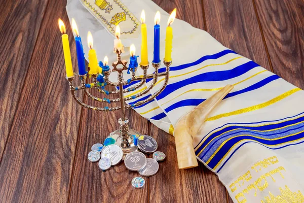 jewish holiday Hanukkah with menorah over wooden table Star David