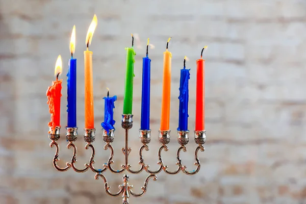 jewish holiday Hanukkah with menorah over wooden background